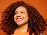 Smiling woman with brown curly hair