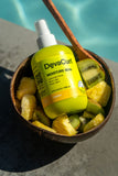 bottle of Moisture Seal in fruit by a pool